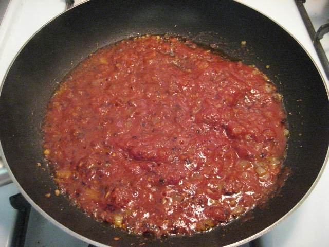 img_3452 Adding the tomato sauce and past to the oil, onions, garlic, and red pepper flakes.